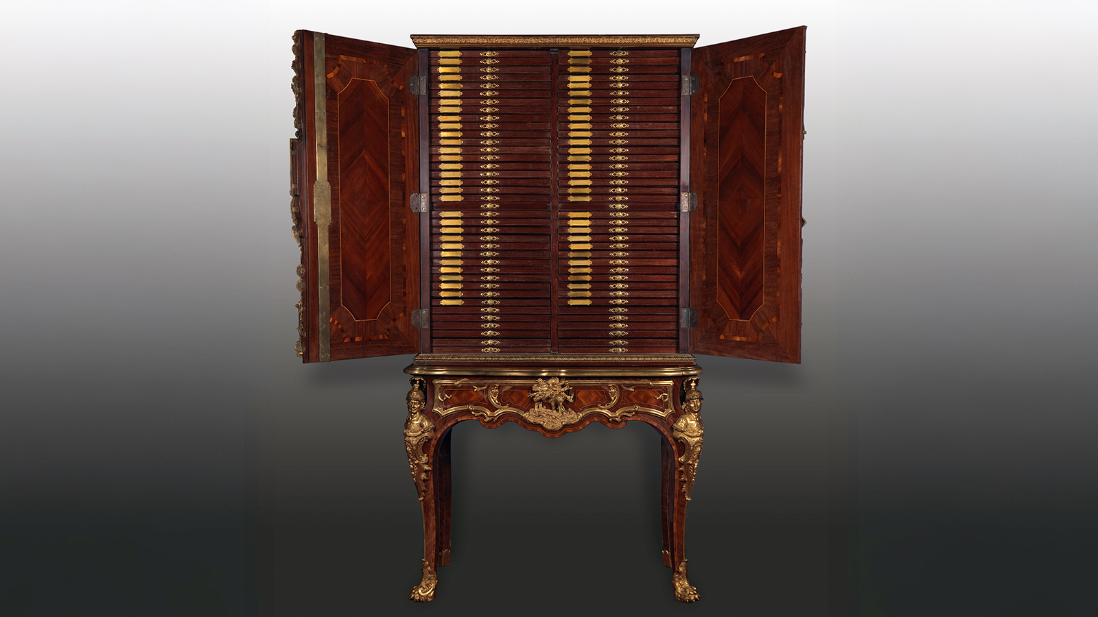 Charles Cressent, Pair of Medal Cabinets. France, c. 1750. Structure in oak veneered with satinwood, amaranth, boxwood, and ebony; chased and gilded bronze. Calouste Gulbenkian Museum, inv. 2368A/B.